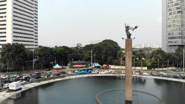 Cinematic aerial view of Bundaran HI Jakarta, Selamat Datang monument.