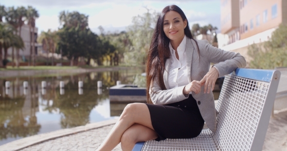 Gorgeous Business Woman Sitting On Bench