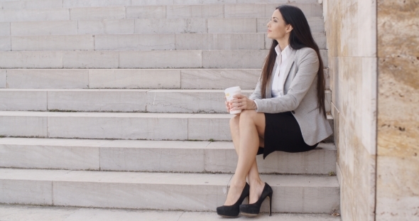 Grinning Woman On Stairs Drinking Coffee