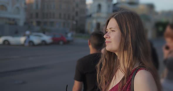 Girl with Long Hair Stands at a Crossroads