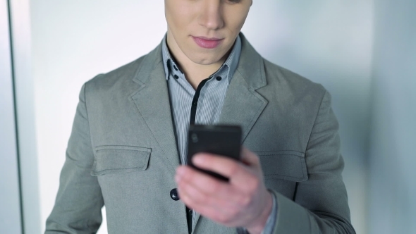 Handsome Businessman Works With The Phone