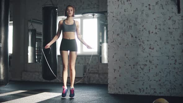 Girl Trains in the Gym in the Early Morning. Athlete Does Cardio Jumping Rope