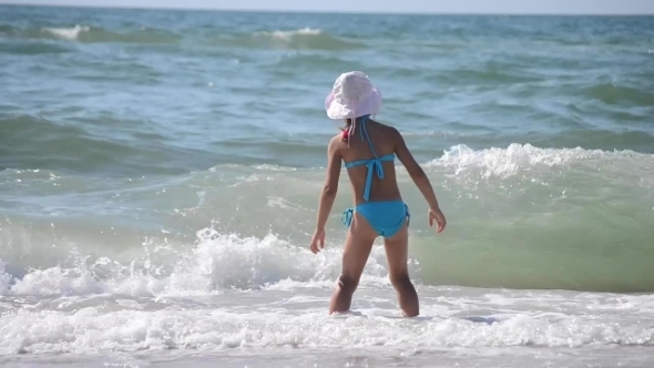 Little Girl Playing In The Sea Waves