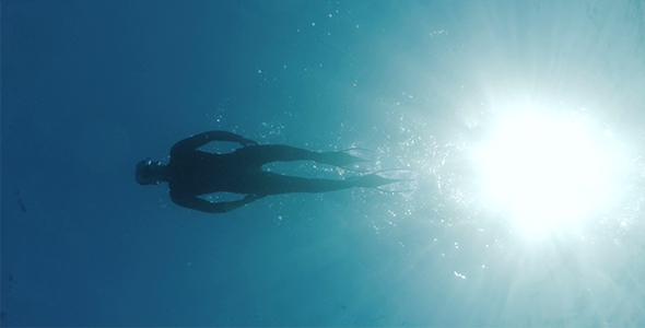 Diver Swimming On Water Surface