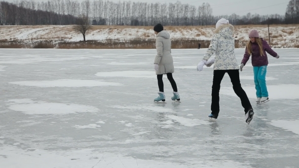 Family Ice Skating On Frozen Lake
