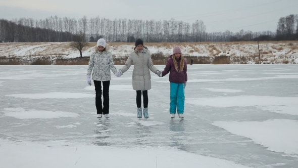 Family Ice Skating On Frozen Lake