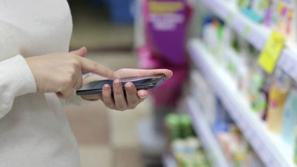 Woman Using the Phone in the Store