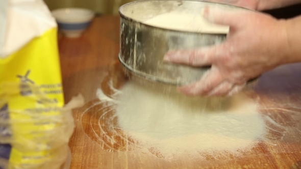 Woman Sifts The Flour Through a Sieve