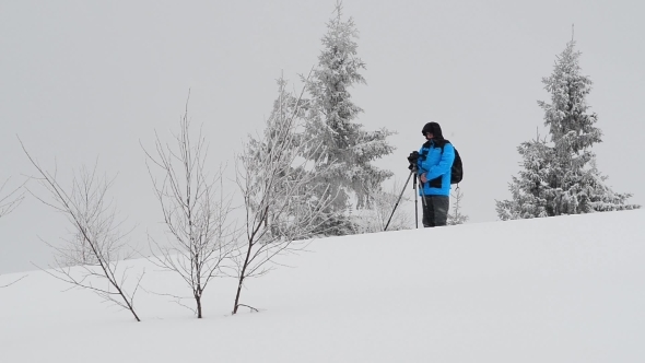 Photographer In Winter Mountain