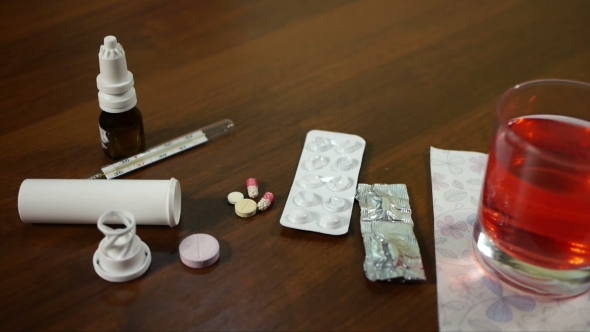 Pills And Thermometer On The Table
