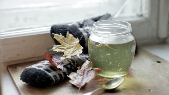 Lemon Tea In The Pot Standing On a Wooden Stand Comes Pairs