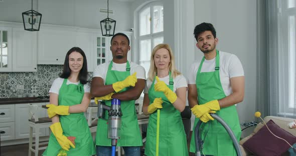 Mixed Race Staff in Special Uniform from Cleaning Service Looking at Camera 