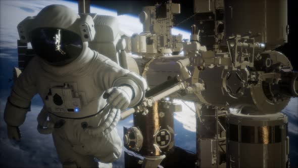 International Space Station and Astronaut in Outer Space Over the Planet Earth alt