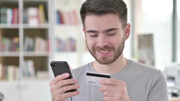 Portrait of Online Payment on Smartphone By Young Man