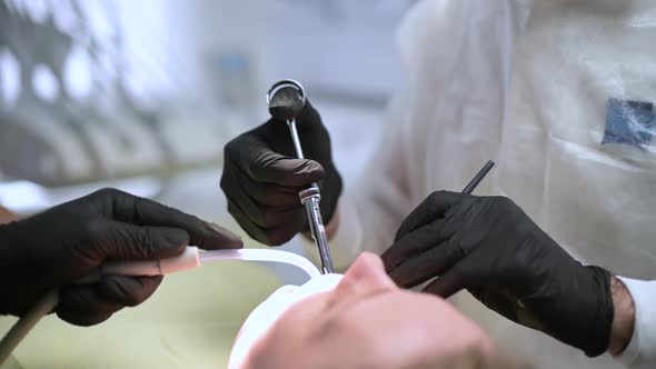 A dentist gives an injection to a patient before an operation on the oral cavity