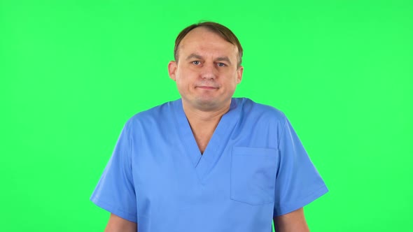 Medical Man Shrugs and Shakes Her Head Negatively, Green Screen