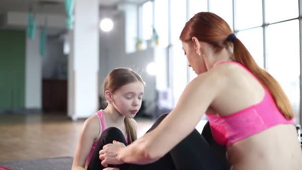 Fitness exercises, for children, a female trainer teaches in the gym