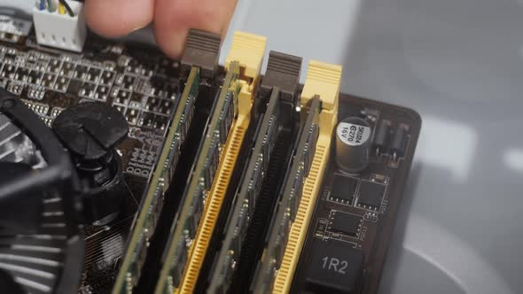 Close Up Man Hands Install Ram Memory on PC Motherboard