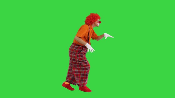 Shh Be Quiet Clown Making Silence Gesture While Walking on a Green Screen Chroma Key