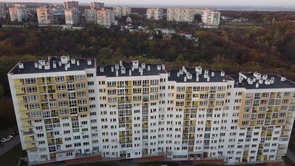 Aerial view of a drone flying over the residential buildings, roof shooting and architecture.