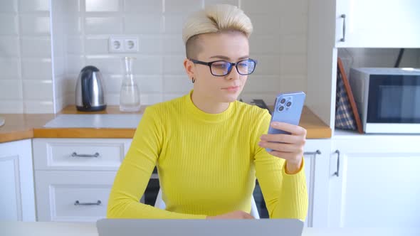 Tomboy female using modern smartphone for entertainment and communication online in 4k video