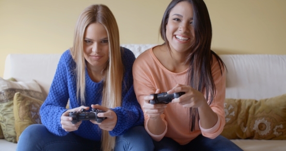 Excited Girls Playing Video Games At Home