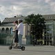 Young Man Rides His Girlfriend on an Electric Scooter in the City Square - VideoHive Item for Sale