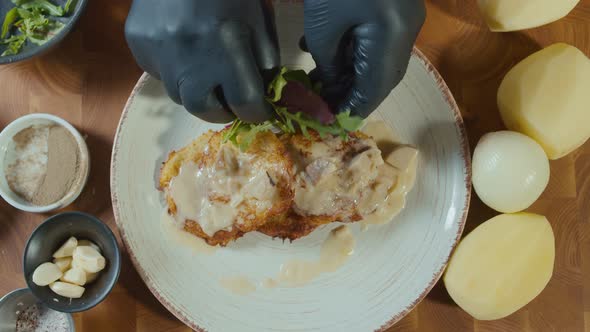 Professional Cook Stylishly Serving Crust Golden Potato Pancakes With Mashrooms