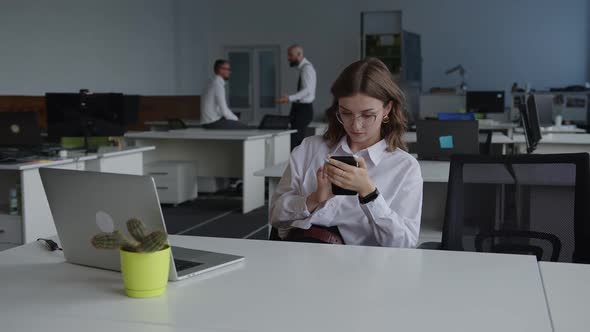 Tired Girl Look on Her Phone During Lunch Time