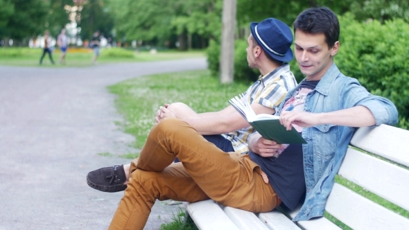 Two Boys Sit On Bench One Read Book, Ask How Much Time Another Boy