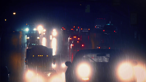 Car Lights Glow On Rainy Night Highway
