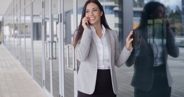 Happy Business Woman On Phone Next To Window alt