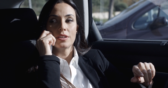 Interior View Of Woman On Phone In Limousine alt