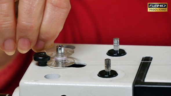 Tailor Preparing Sewing Machine