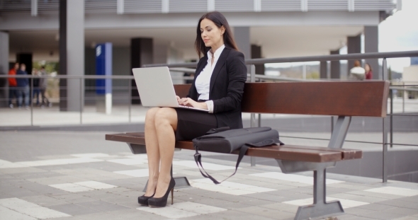 Business Woman Alone With Laptop On Bench