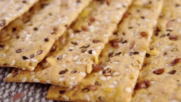 Crunchy crispbreads with falling sesame and flax seeds. Healthy dietary food. Macro