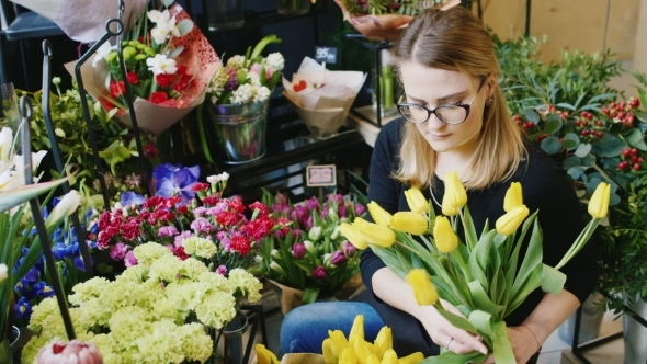 Woman Florist Assembles Bouquet In Flower Shop