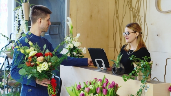 Good Looking Man Buys a Bouquet At a Flower Shop
