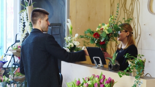 Attractive Man Buys a Bouquet At a Flower Shop