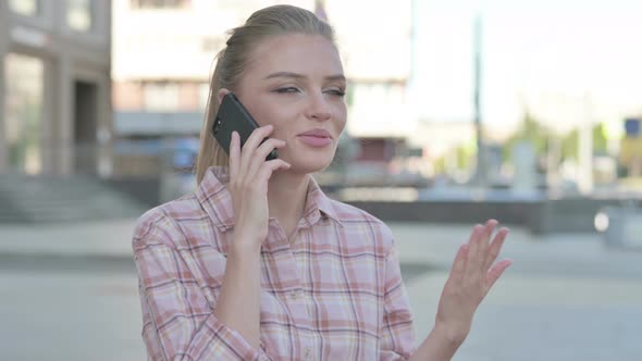 Young Woman Talking on Phone While Standing Outdoor