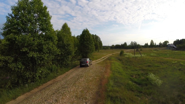 Car and Cobbled Road