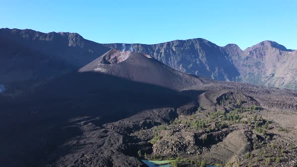 Closing in the crater cone of Mount Rinjani active volcano in Indonesia, Nusa Tenggara, Aerial dolly