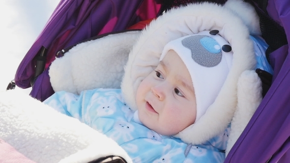 Portrait Of Cute Baby In Pram At Winter