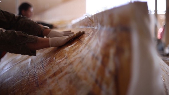 Construction of Boats at the Shipyard, Gluing Fiberglass