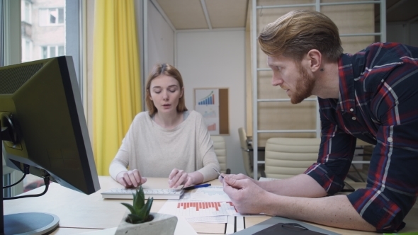 Unhappy Woman Making a Credit Card Which Dictates Man alt