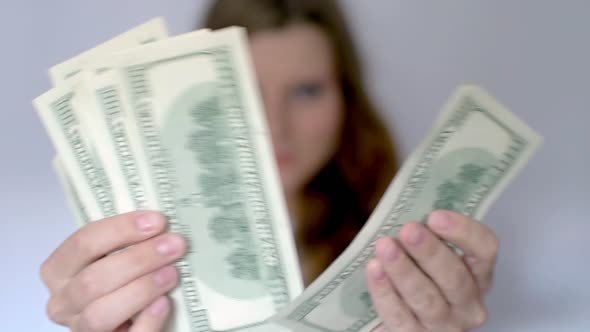 Young Woman With Fistfuls Of Money