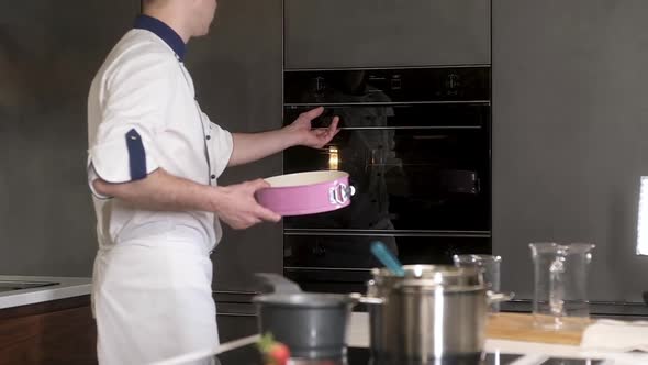 professional cook carries the dishes with the dough and puts them in the oven