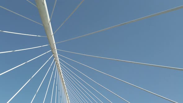 stabilized shot with movement of cables from a bridge and blue sky in the background