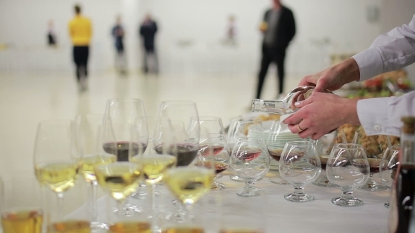 Waiter Pouring Brandy Into Glasses At a Reception 