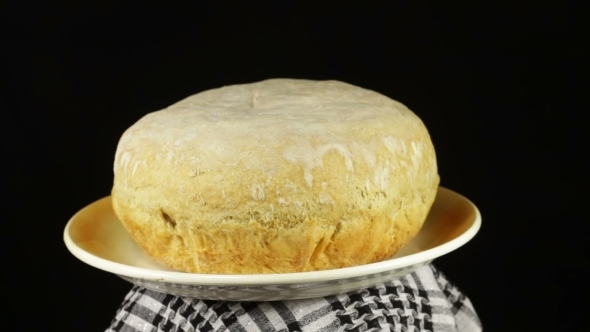 Homemade Bread on The Table Rotates on a Black Background